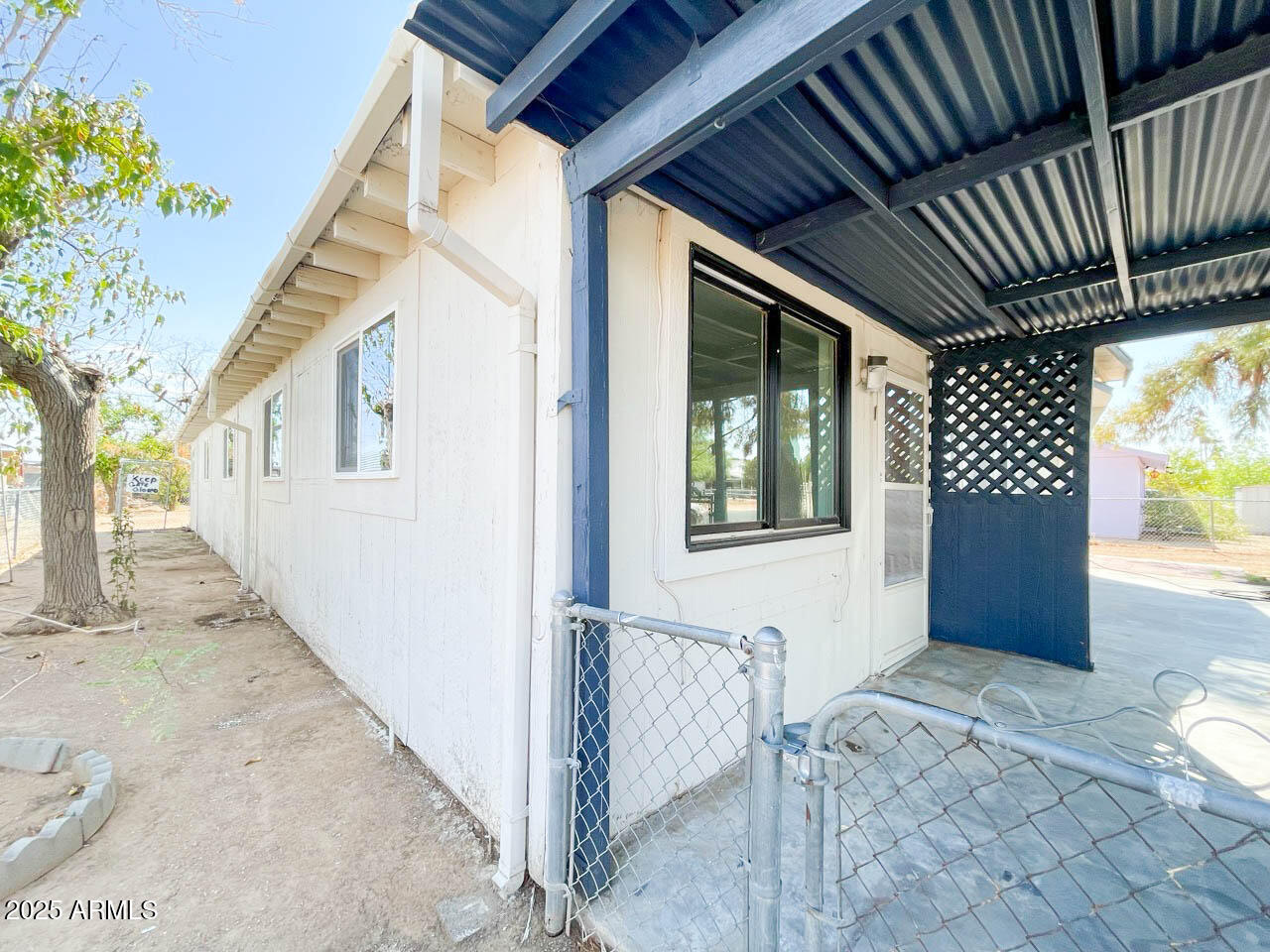 8125 East 5th Avenue Mesa, AZ 85208 - Photo 7 of 46 a view of house with backyard and glass door