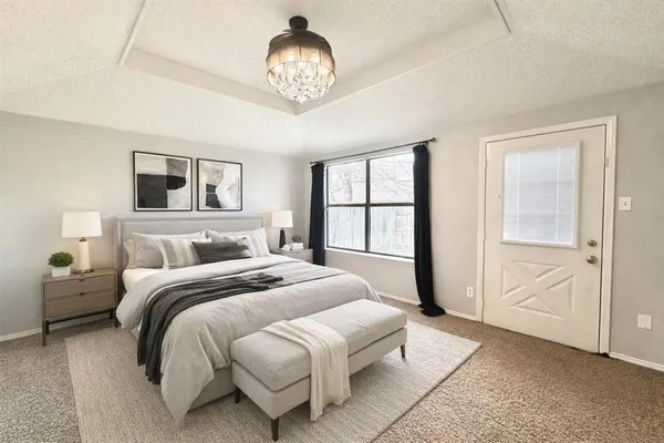 a bedroom with bed and a chandelier