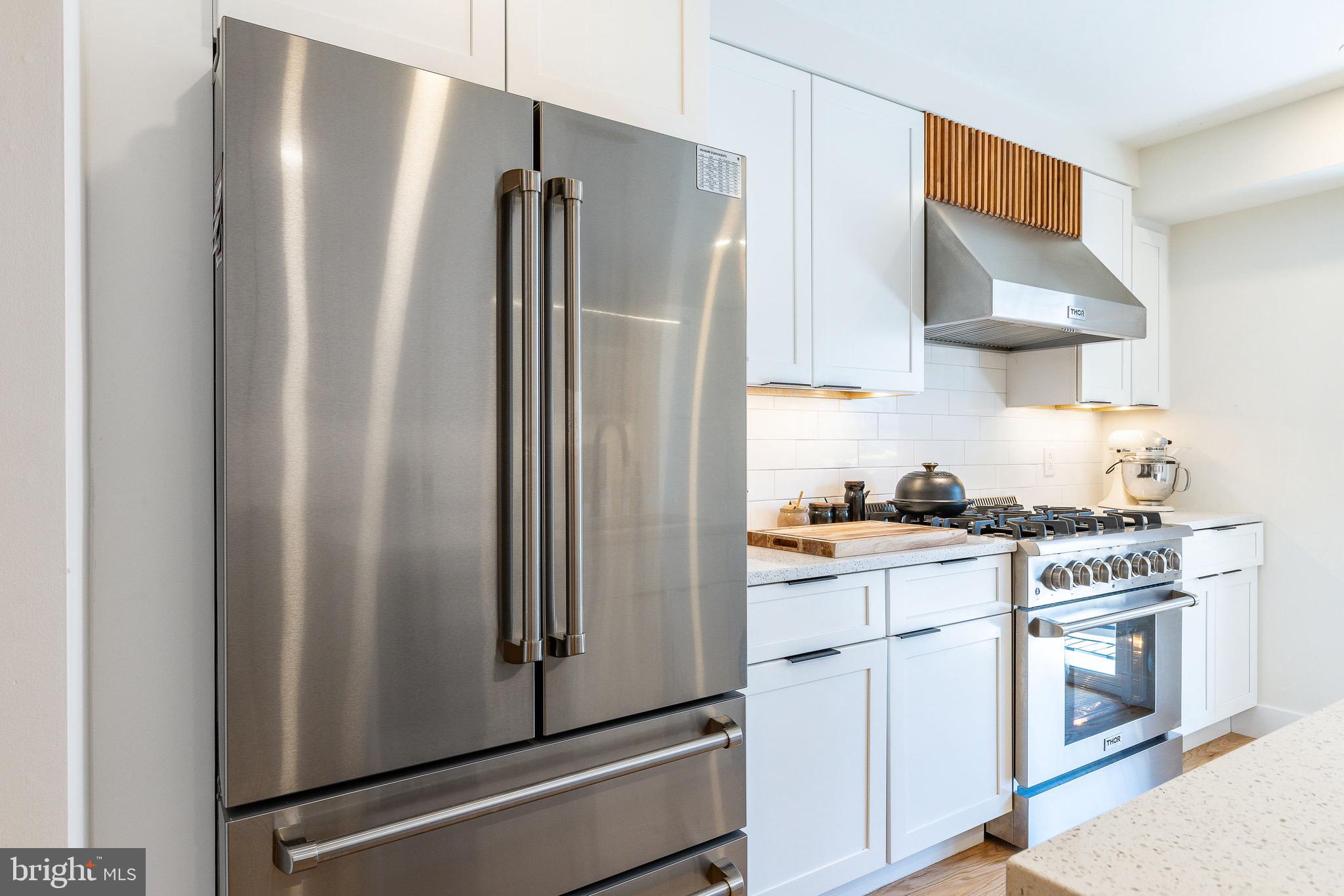 530 Reed Street Philadelphia, PA 19147 - Photo 11 of 57 a kitchen with stainless steel appliances a refrigerator stove and sink