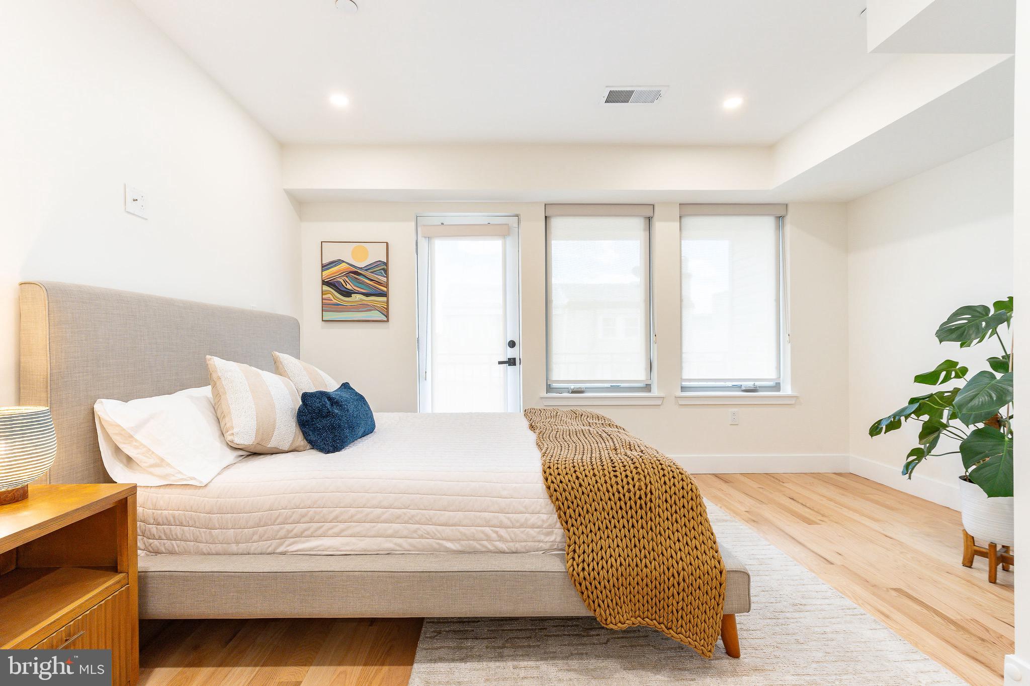 530 Reed Street Philadelphia, PA 19147 - Photo 18 of 57 a bedroom with a large bed and a couch