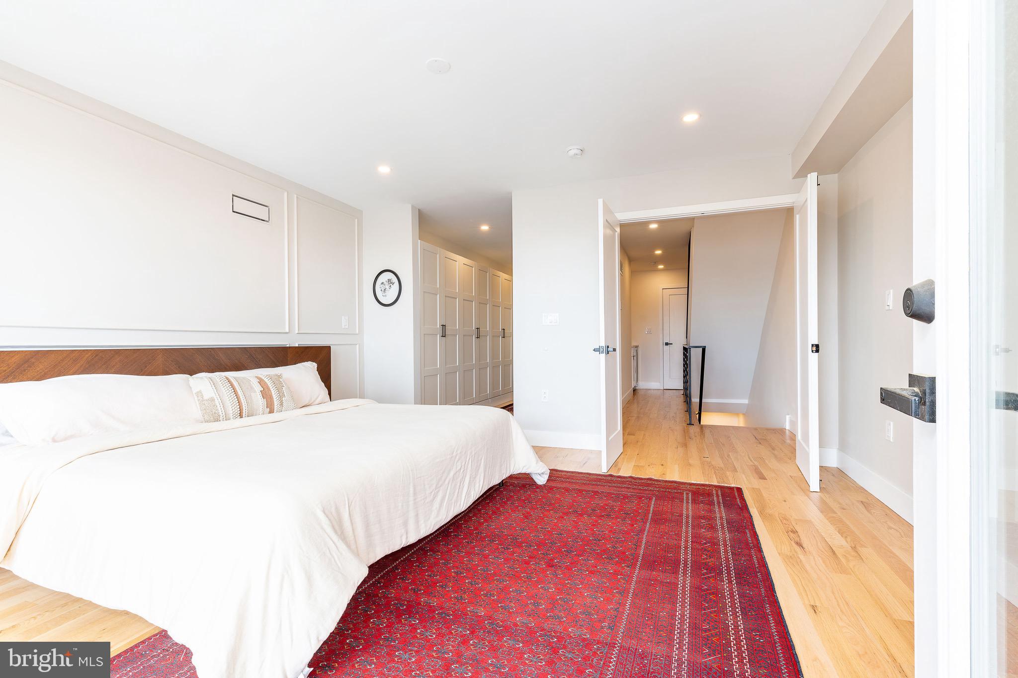 530 Reed Street Philadelphia, PA 19147 - Photo 30 of 57 a spacious bedroom with a bed and a view of bathroom