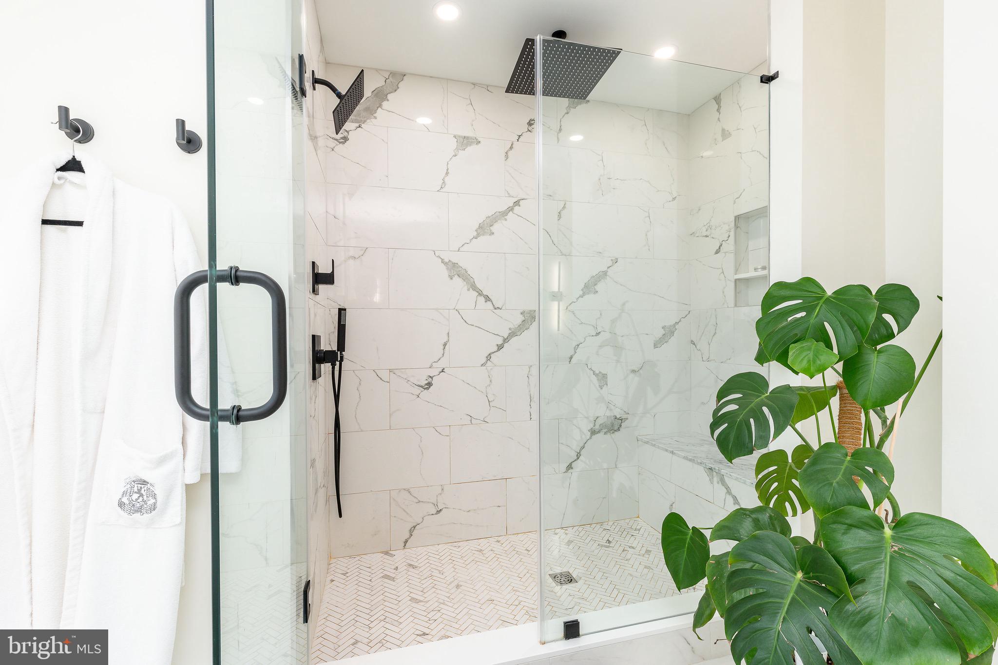 530 Reed Street Philadelphia, PA 19147 - Photo 39 of 57 a bathroom with a granite countertop shower a mirror and a shower