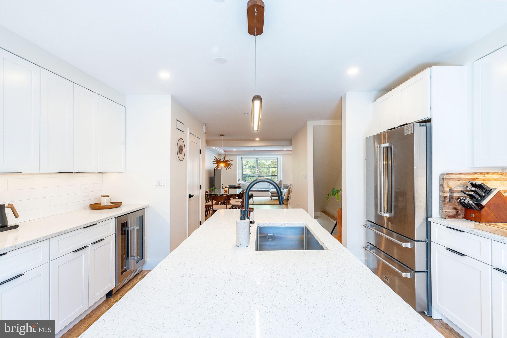 530 Reed Street Philadelphia, PA 19147 - Photo 8 of 57 a view of a kitchen with kitchen island a counter top space a sink stainless steel appliances and cabinets