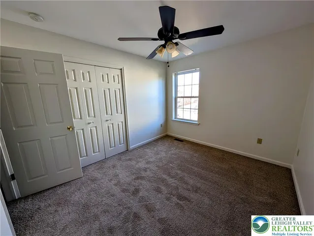 a view of an empty room and a window