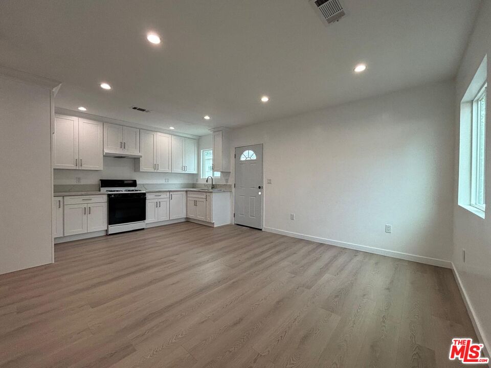 a view of a kitchen with a sink and a stove top oven
