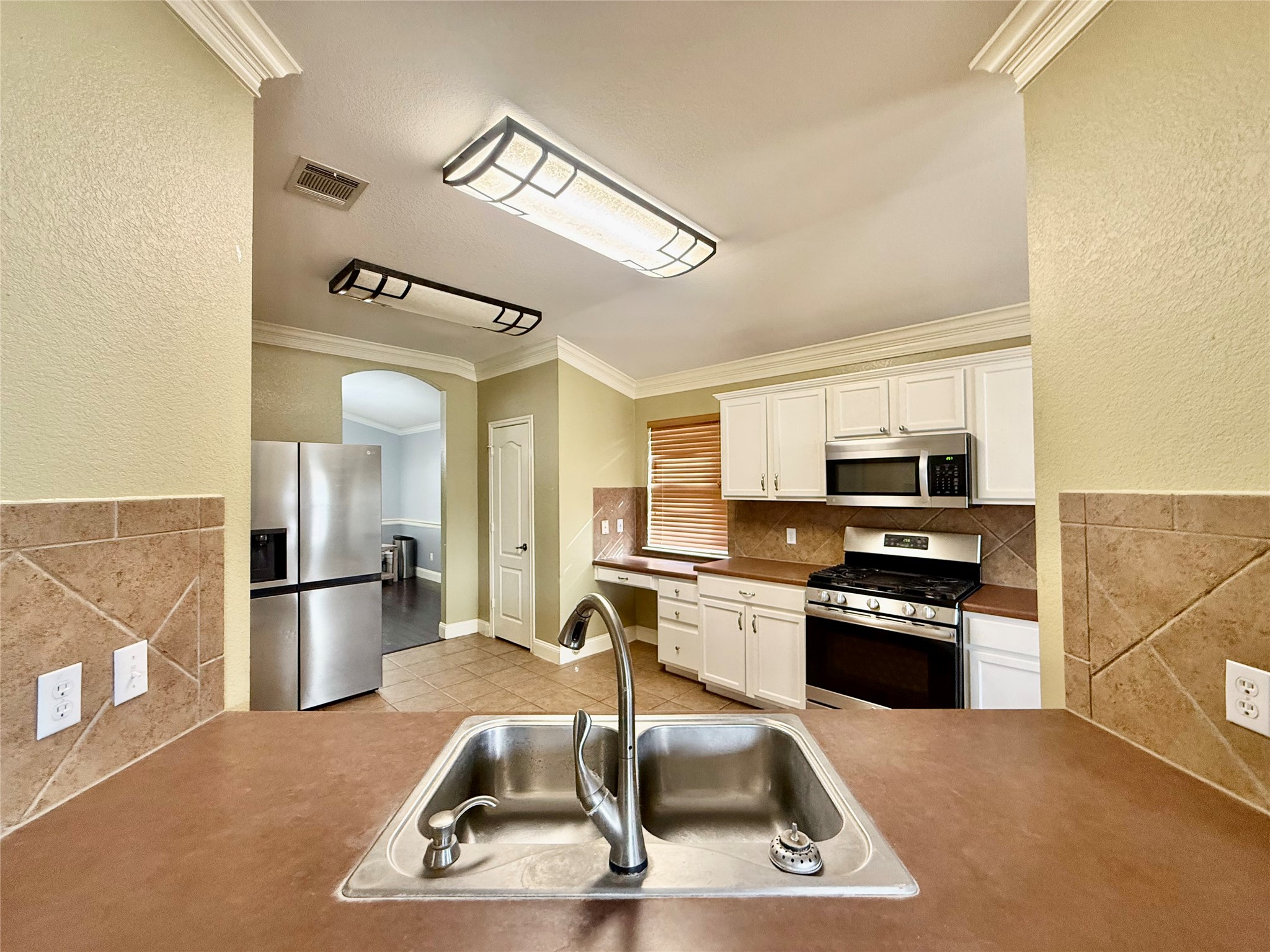 12820 Waynespur Lane Elgin, TX 78621 - Photo 11 of 26 a kitchen with stainless steel appliances granite countertop a sink stove and refrigerator