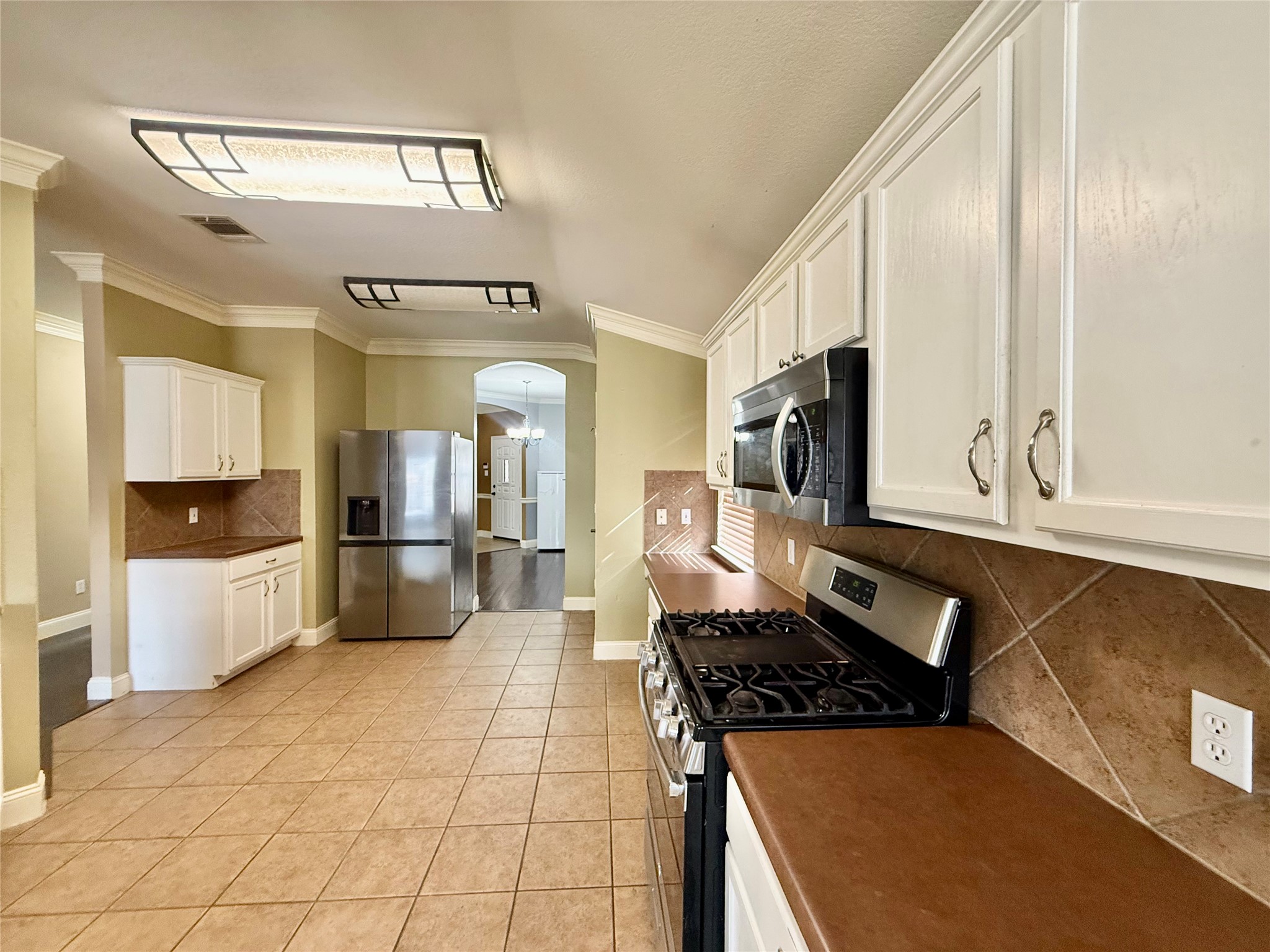 12820 Waynespur Lane Elgin, TX 78621 - Photo 12 of 26 a kitchen with stainless steel appliances granite countertop a stove a sink and a refrigerator
