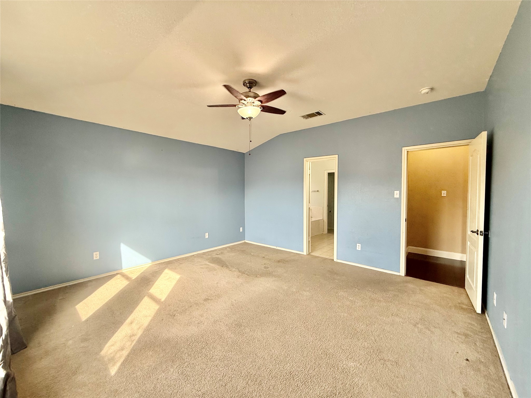 12820 Waynespur Lane Elgin, TX 78621 - Photo 15 of 26 a view of a big room with closet and a chandelier fan