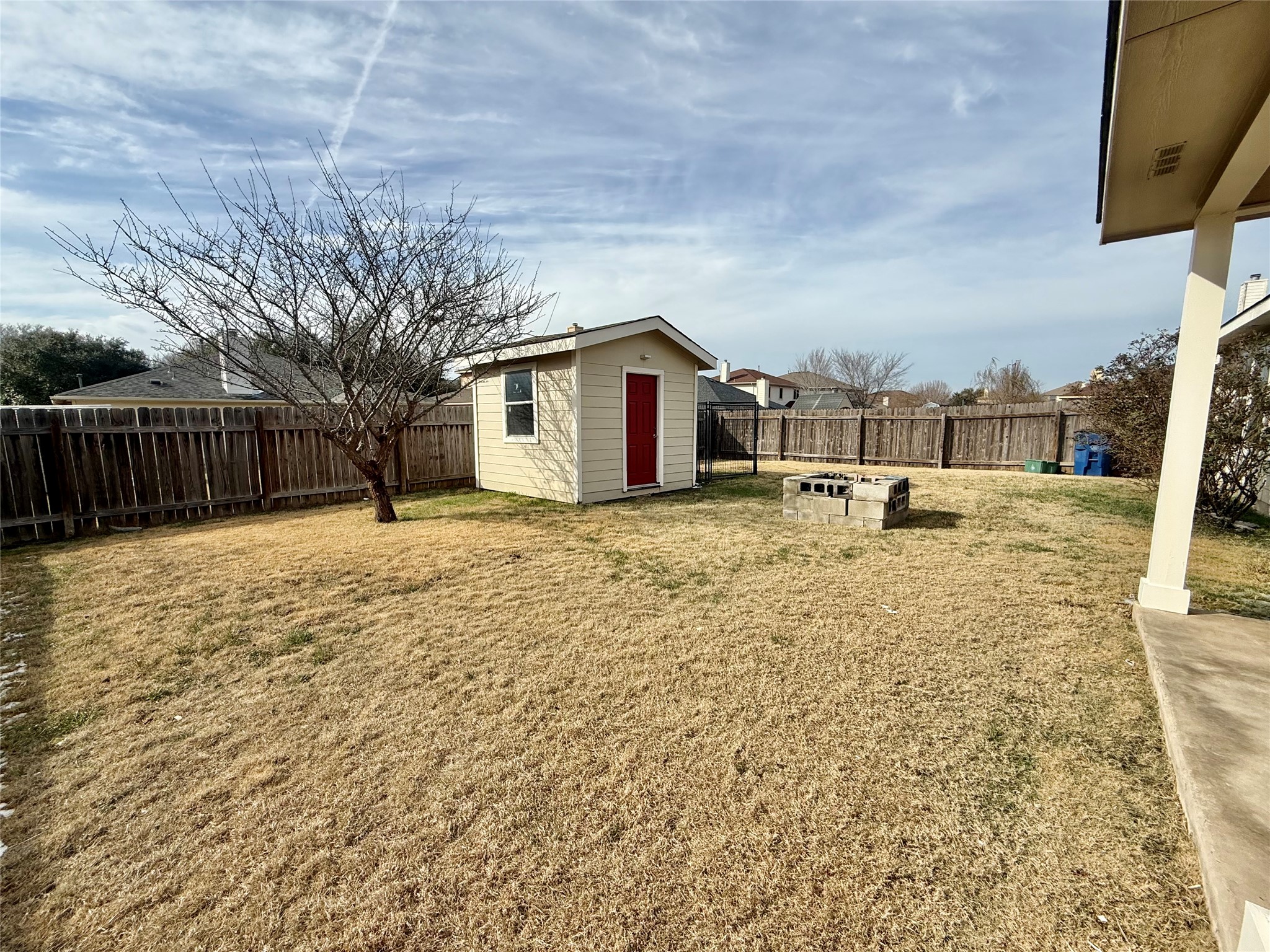 12820 Waynespur Lane Elgin, TX 78621 - Photo 23 of 26 a view of a house with a yard covered in snow