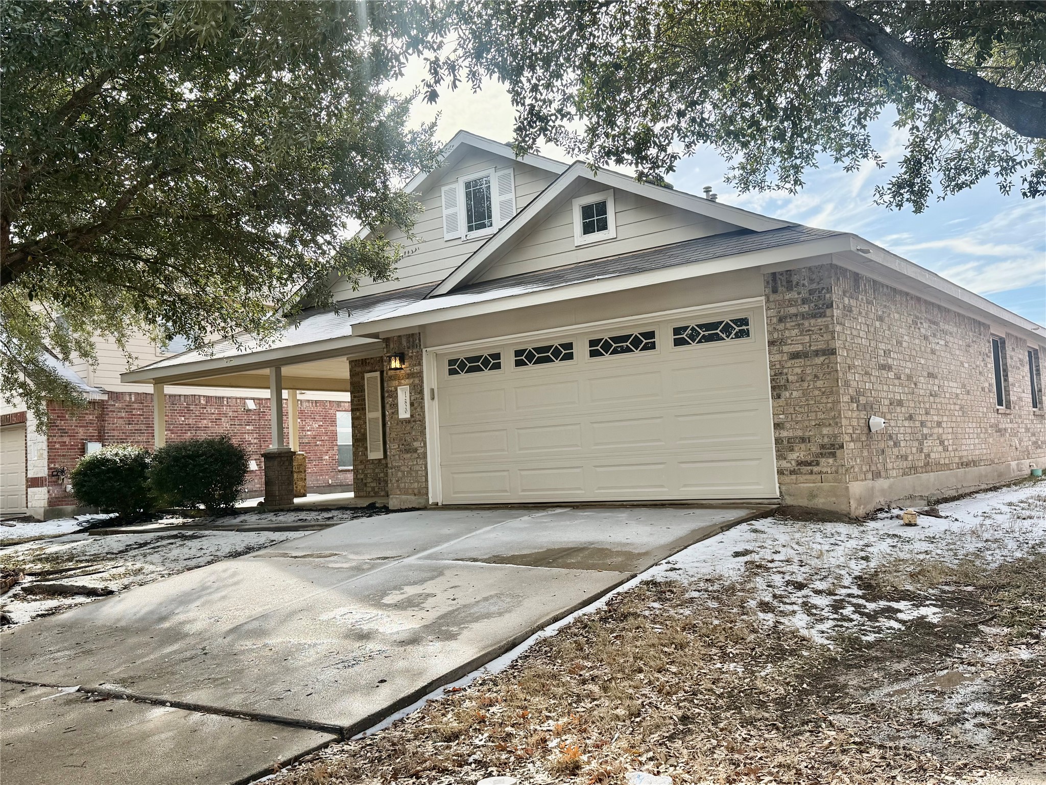 12820 Waynespur Lane Elgin, TX 78621 - Photo 26 of 26 a front view of a house with a yard and garage