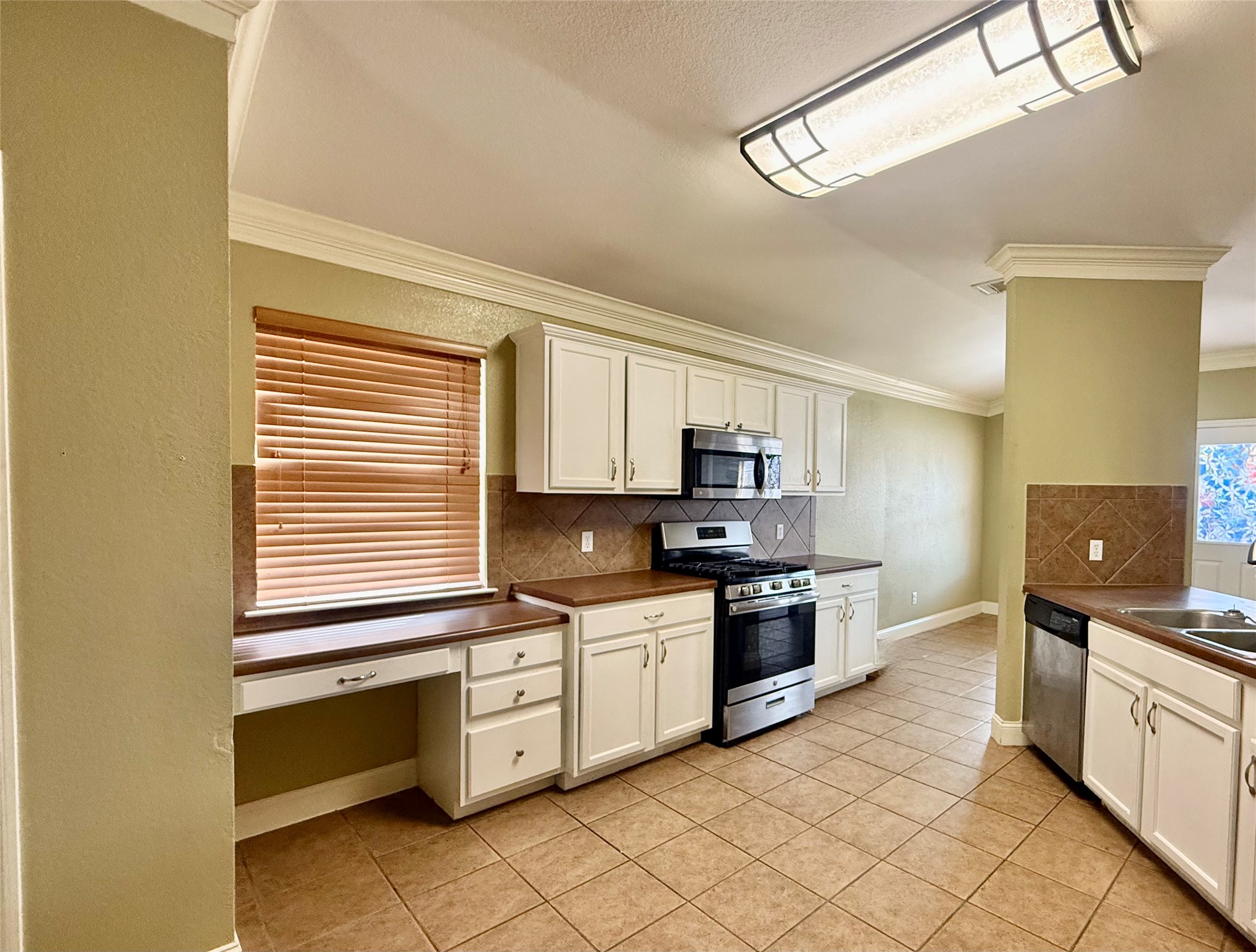 12820 Waynespur Lane Elgin, TX 78621 - Photo 10 of 26 a kitchen with stainless steel appliances granite countertop a stove and a sink