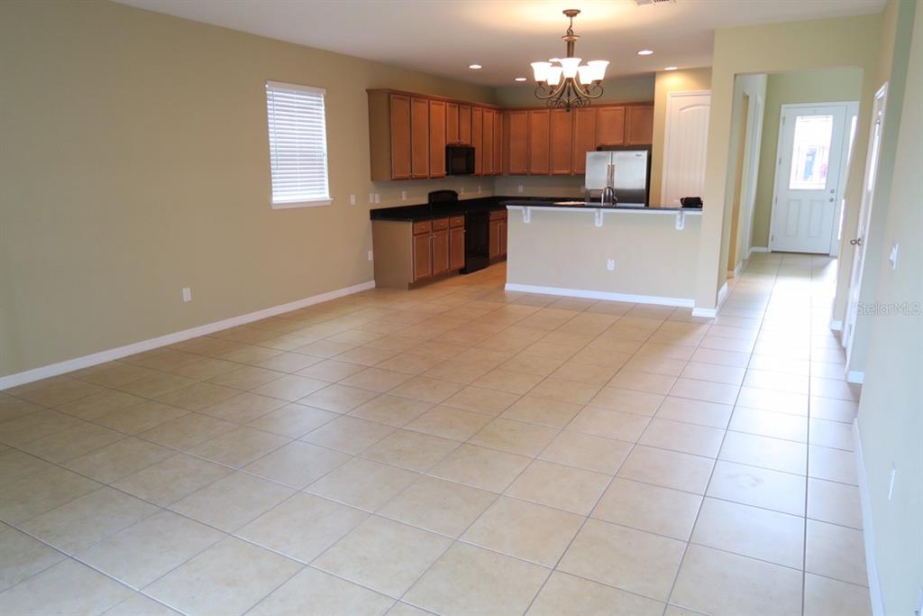 a large kitchen with kitchen island a sink a counter space and stainless steel appliances
