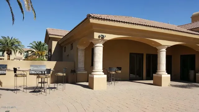 a living room with furniture a chandelier and a large window