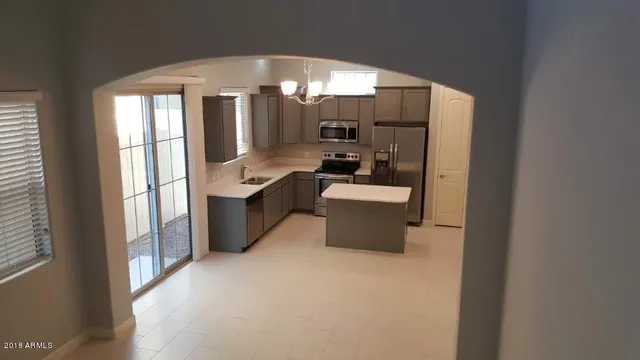 a large white kitchen with a large window