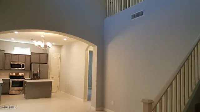a view of kitchen with furniture and refrigerator
