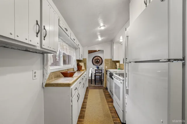 a kitchen with granite countertop a sink and washing machine