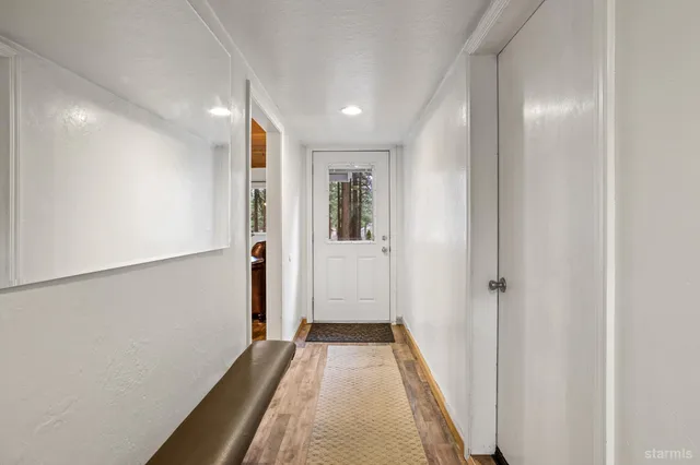 a view of a hallway with wooden floor