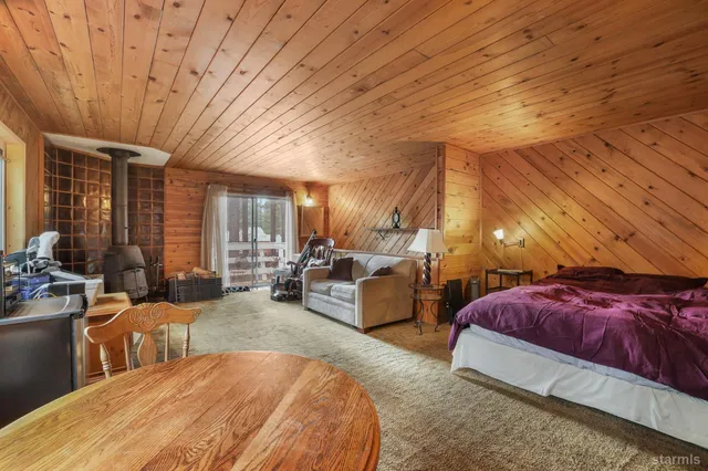 a bed room with furniture and a large window