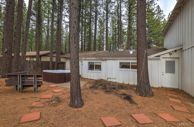 a view of a house with backyard and sitting area
