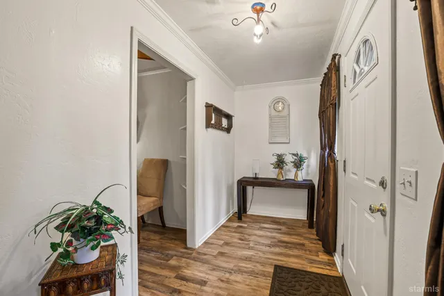 a view of a hallway to a livingroom with furniture