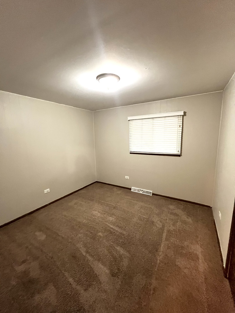 2843 193rd Street Lansing, IL 60438 - Photo 8 of 17 an empty room with a empty space and windows