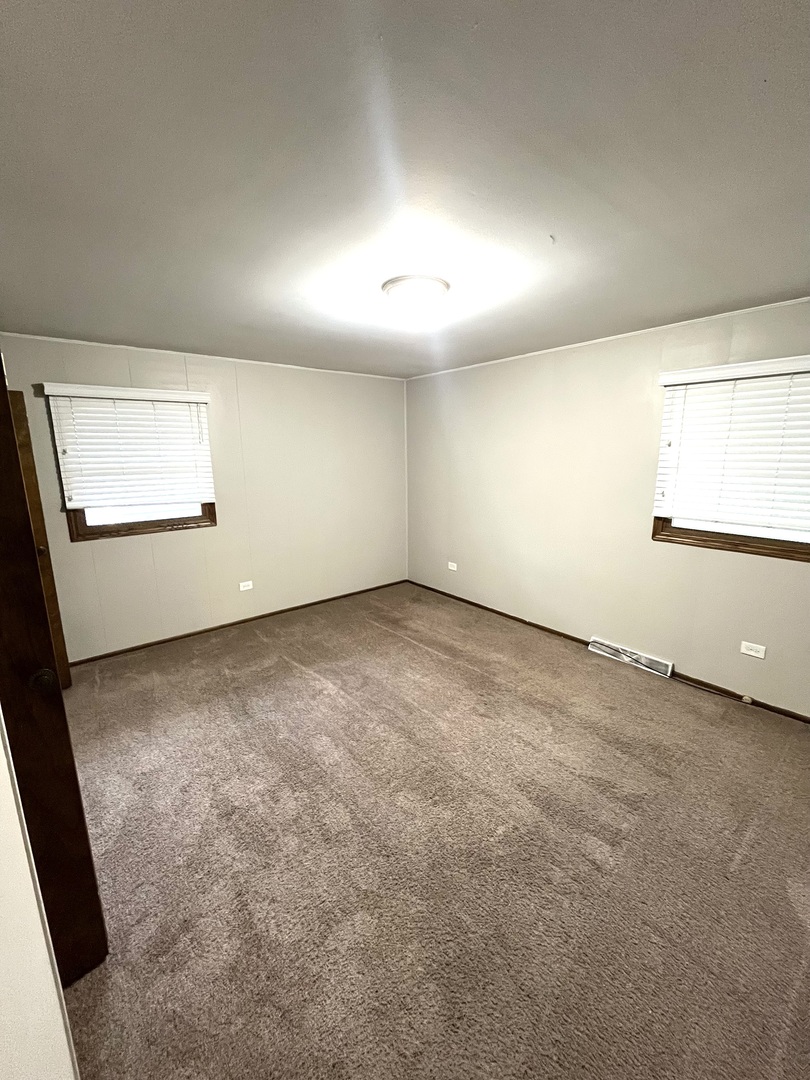 2843 193rd Street Lansing, IL 60438 - Photo 10 of 17 an empty room with a empty space and windows