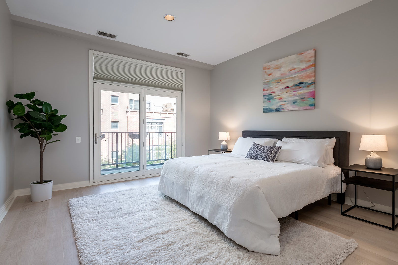 550 West Fulton Street, Unit 301 Chicago, IL 60661 - Photo 12 of 26 a bedroom with bed and a potted plant