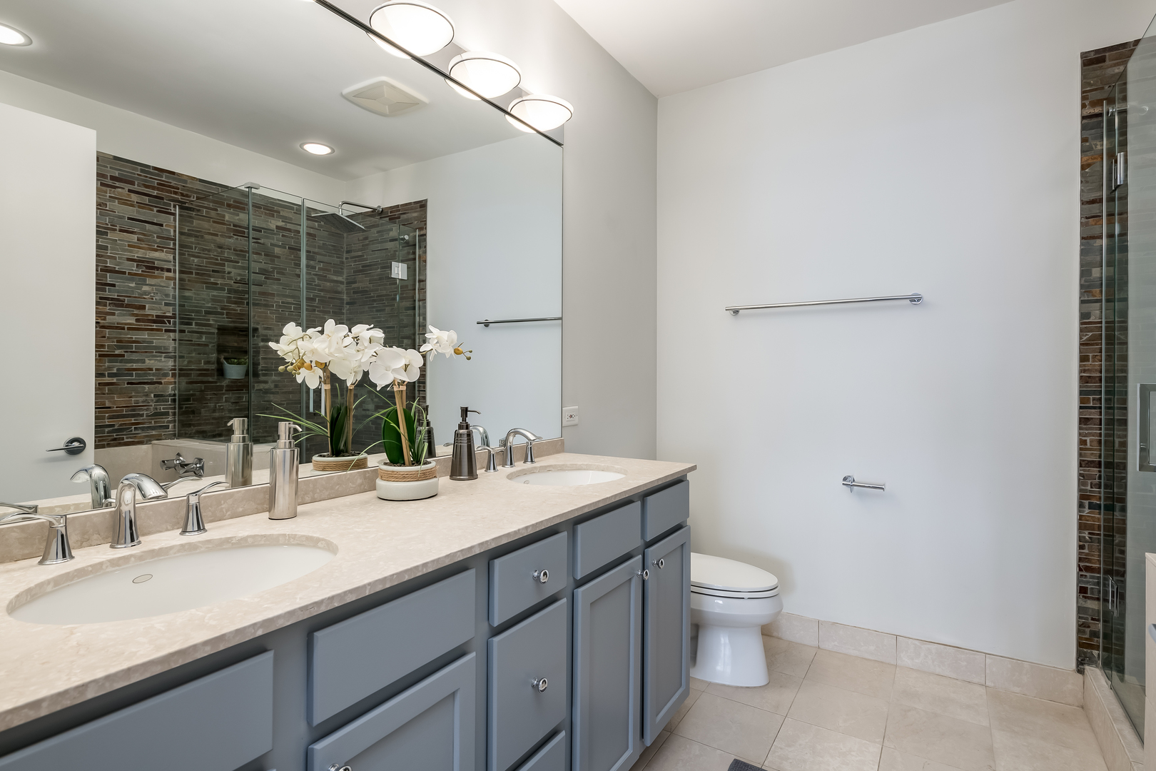 550 West Fulton Street, Unit 301 Chicago, IL 60661 - Photo 14 of 26 a bathroom with a granite countertop sink toilet and shower
