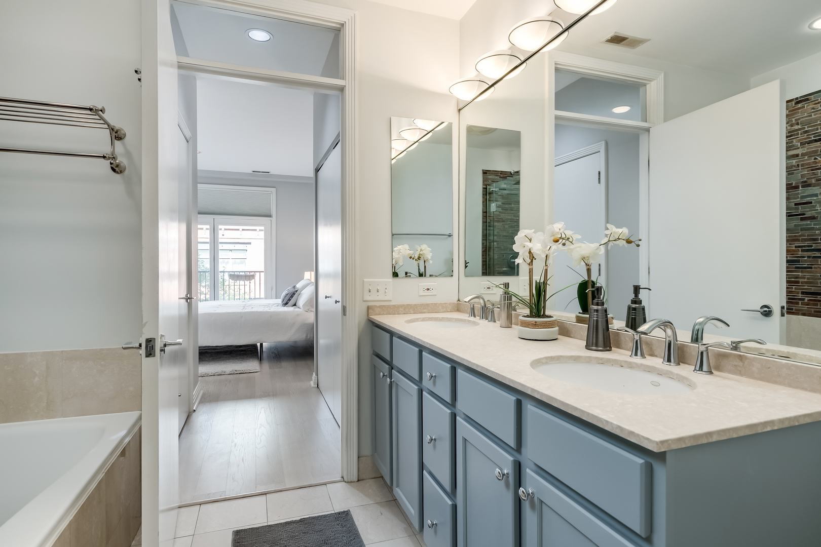 550 West Fulton Street, Unit 301 Chicago, IL 60661 - Photo 15 of 26 a en suite bathroom with a sink a toilet and a mirror