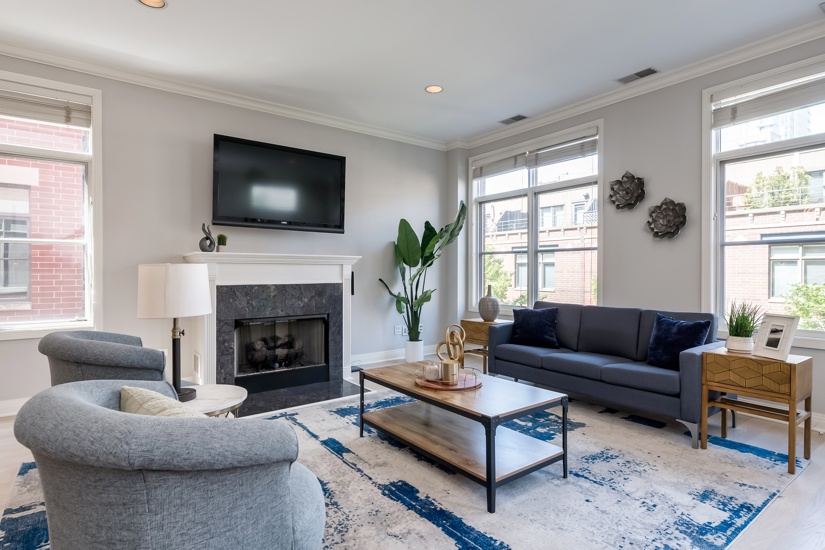 550 West Fulton Street, Unit 301 Chicago, IL 60661 - Photo 5 of 26 a living room with furniture flat screen tv and a fireplace