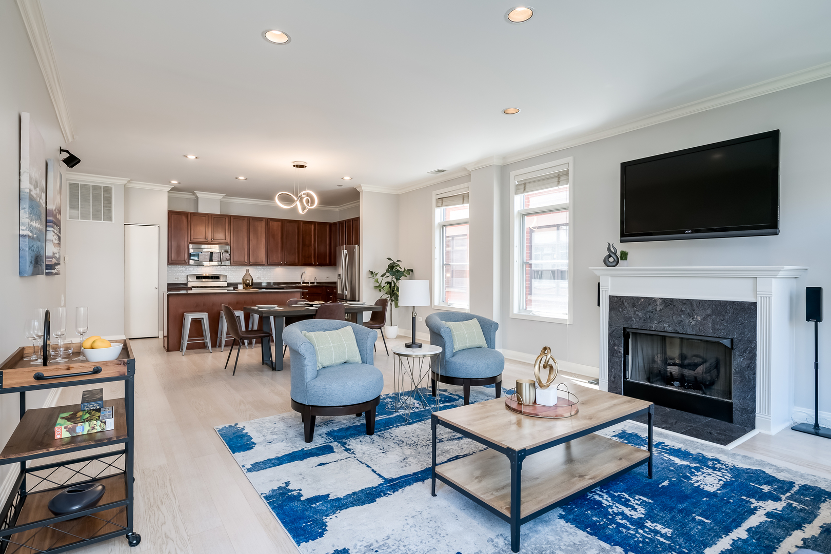 550 West Fulton Street, Unit 301 Chicago, IL 60661 - Photo 6 of 26 a living room with furniture a flat screen tv and a fireplace