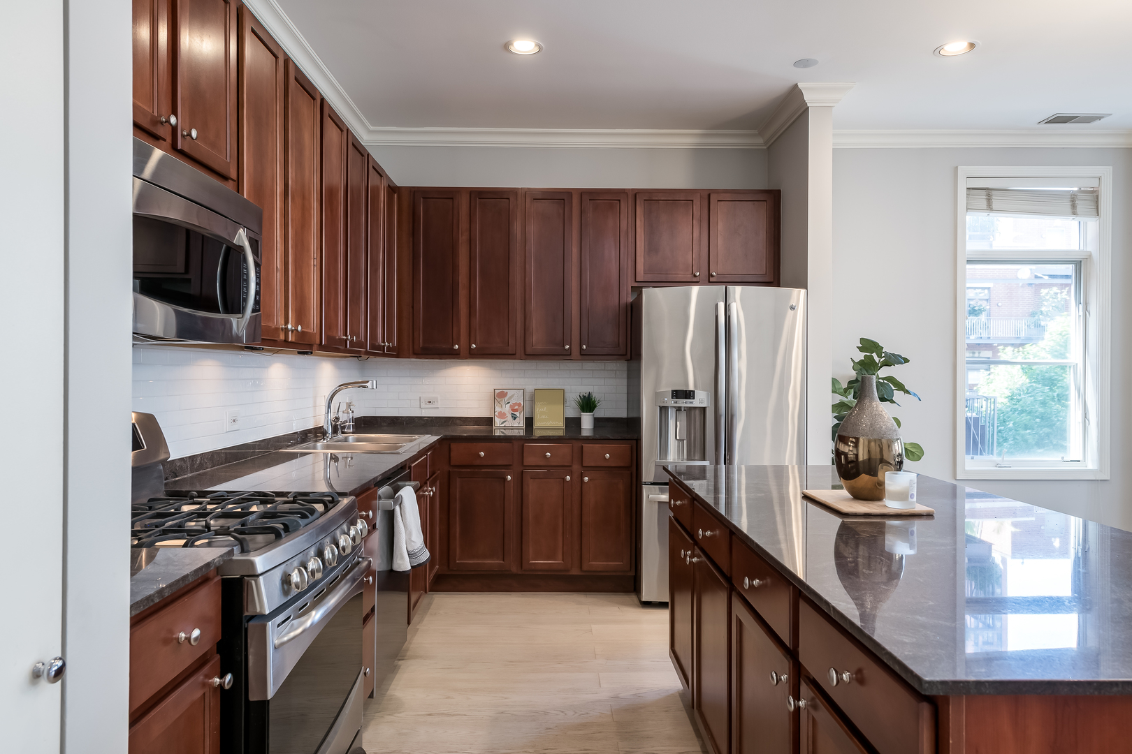 550 West Fulton Street, Unit 301 Chicago, IL 60661 - Photo 8 of 26 a kitchen with stainless steel appliances granite countertop a stove a sink dishwasher a refrigerator and a microwave