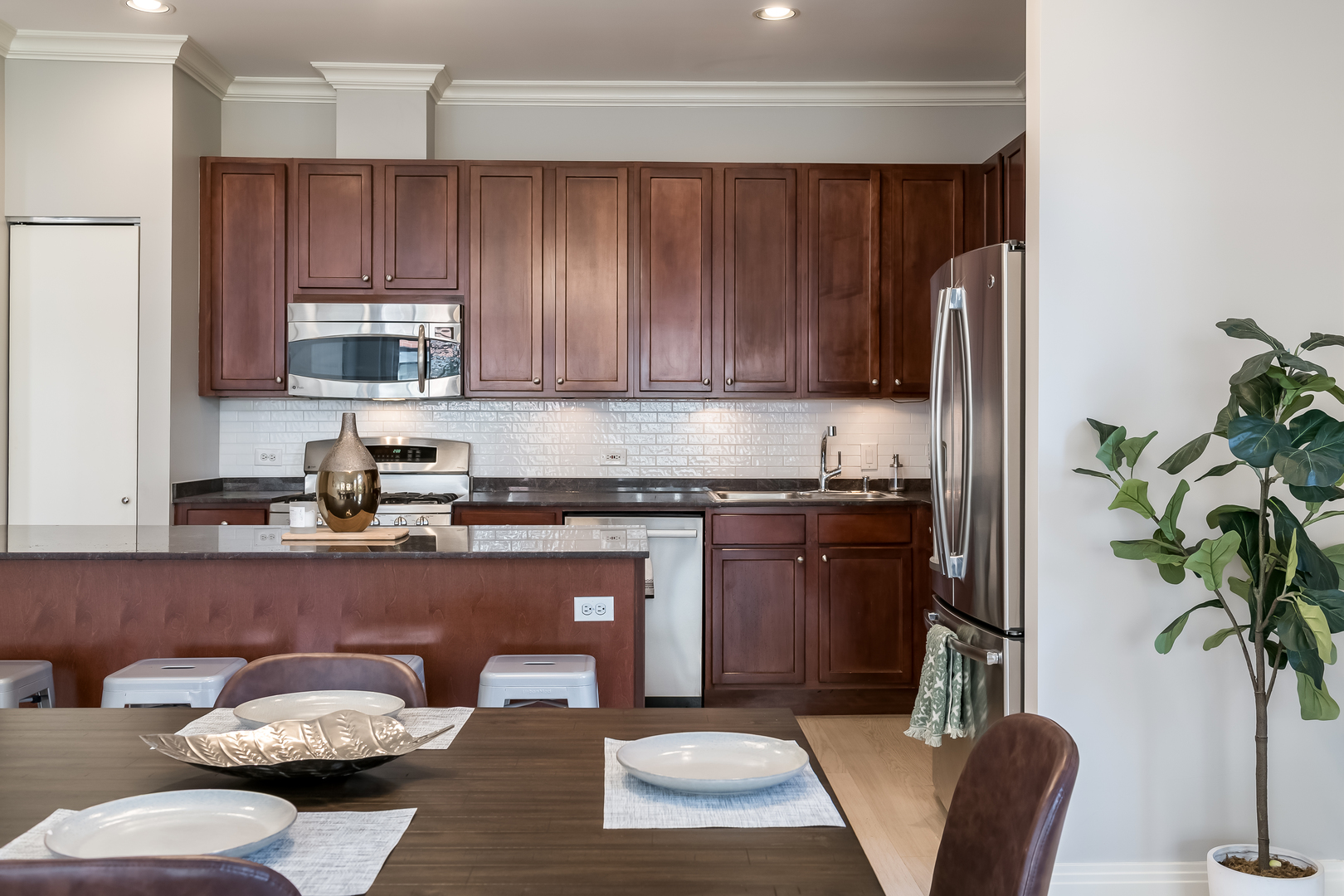 550 West Fulton Street, Unit 301 Chicago, IL 60661 - Photo 10 of 26 a kitchen with a refrigerator and a stove top oven