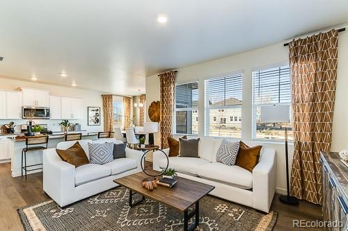 763 Ayrshire Road Johnstown, CO 80534 - Photo 4 of 31 a living room with furniture wooden floor and a table