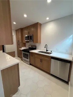 a kitchen with sink cabinets and stainless steel appliances