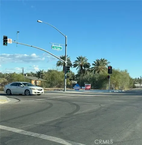 a view of a cars parked on the side of a street
