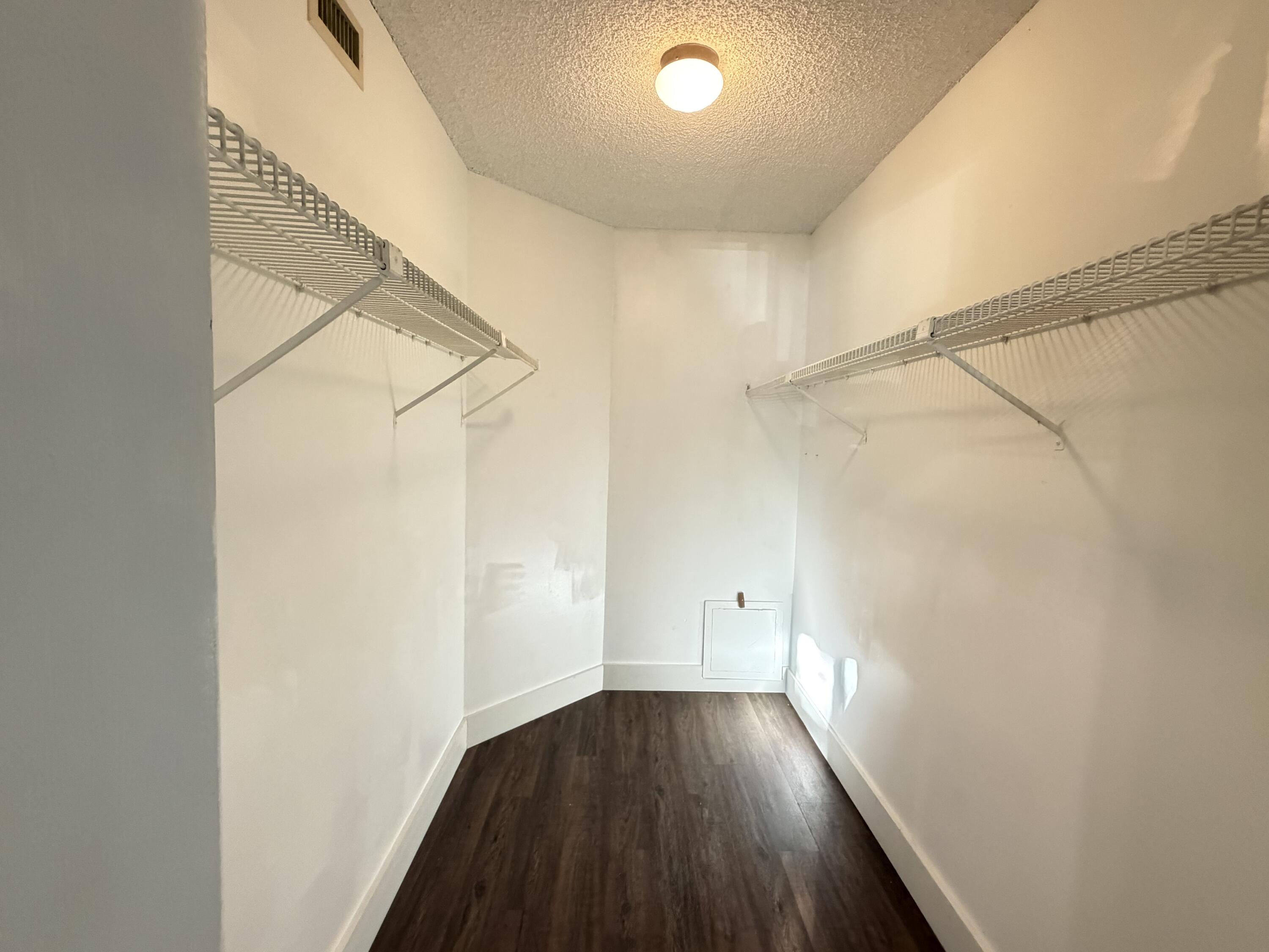 921 Lyons Road, Unit 3205 Coconut Creek, FL 33063 - Photo 11 of 17 a view of a hallway with wooden floor