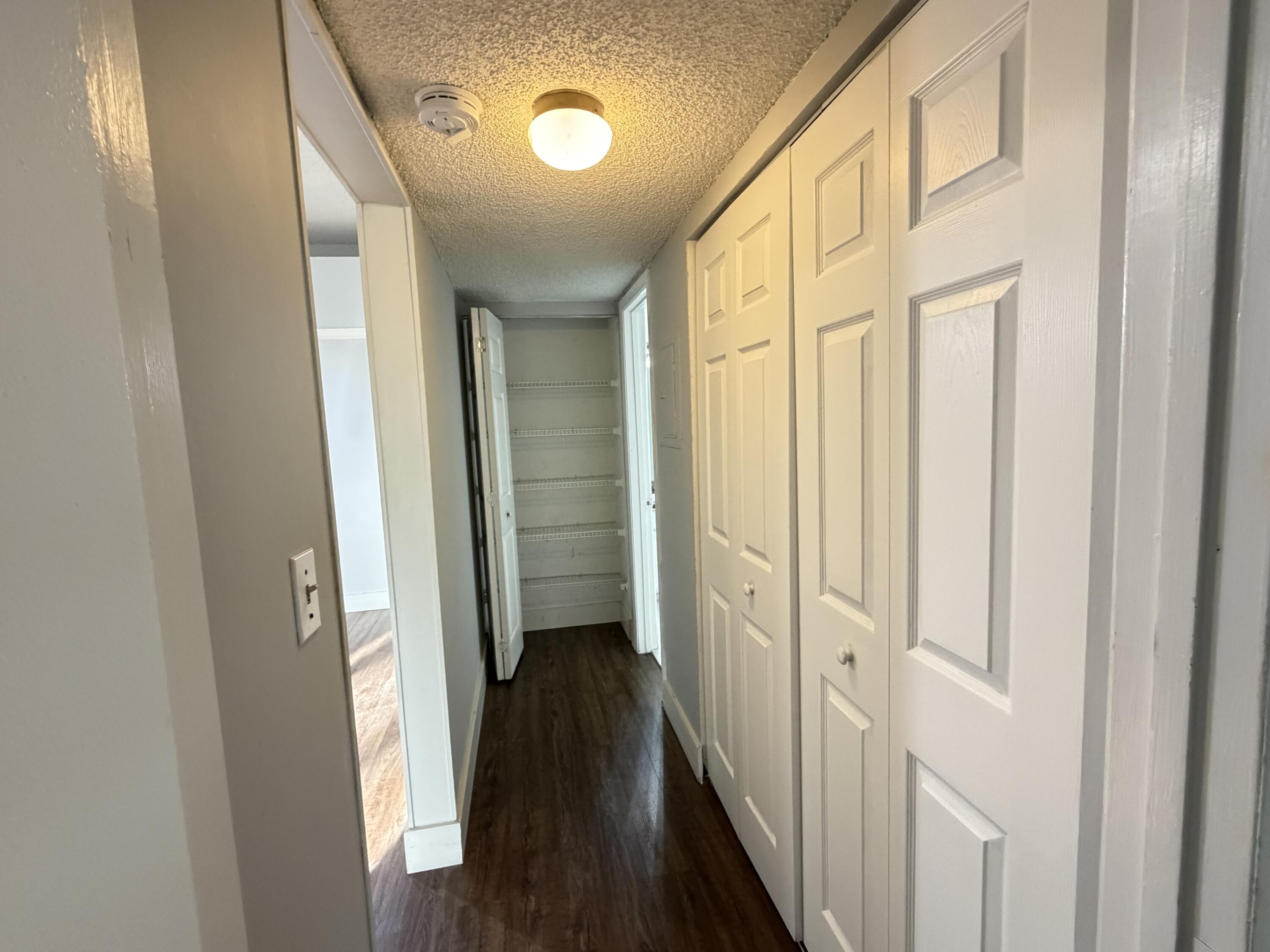 921 Lyons Road, Unit 3205 Coconut Creek, FL 33063 - Photo 12 of 17 a view of a hallway with a wooden door