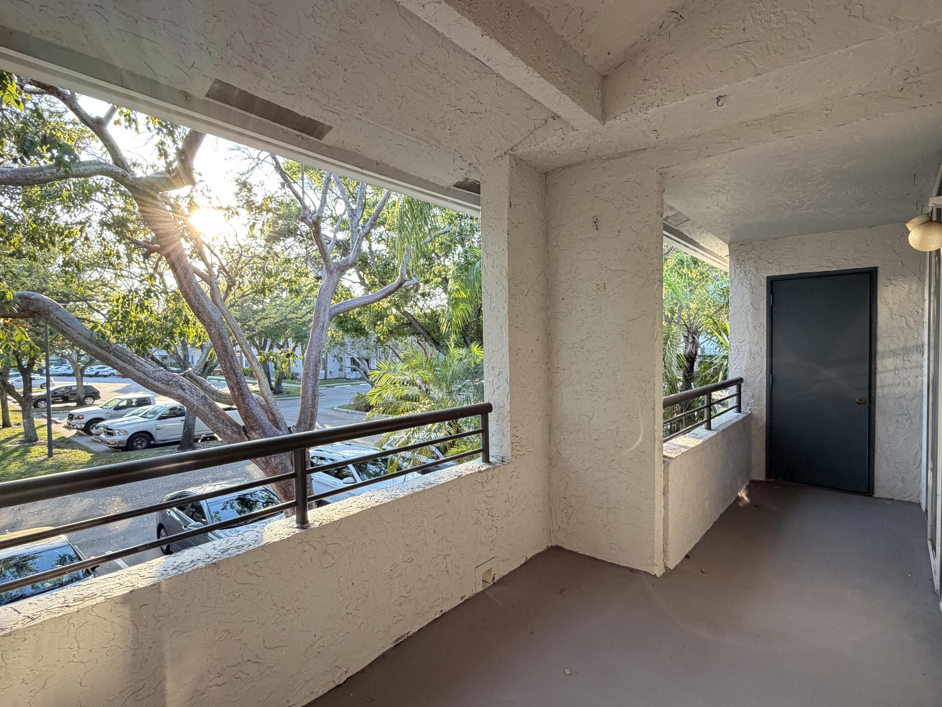 921 Lyons Road, Unit 3205 Coconut Creek, FL 33063 - Photo 15 of 17 a view of an empty room with furniture and window