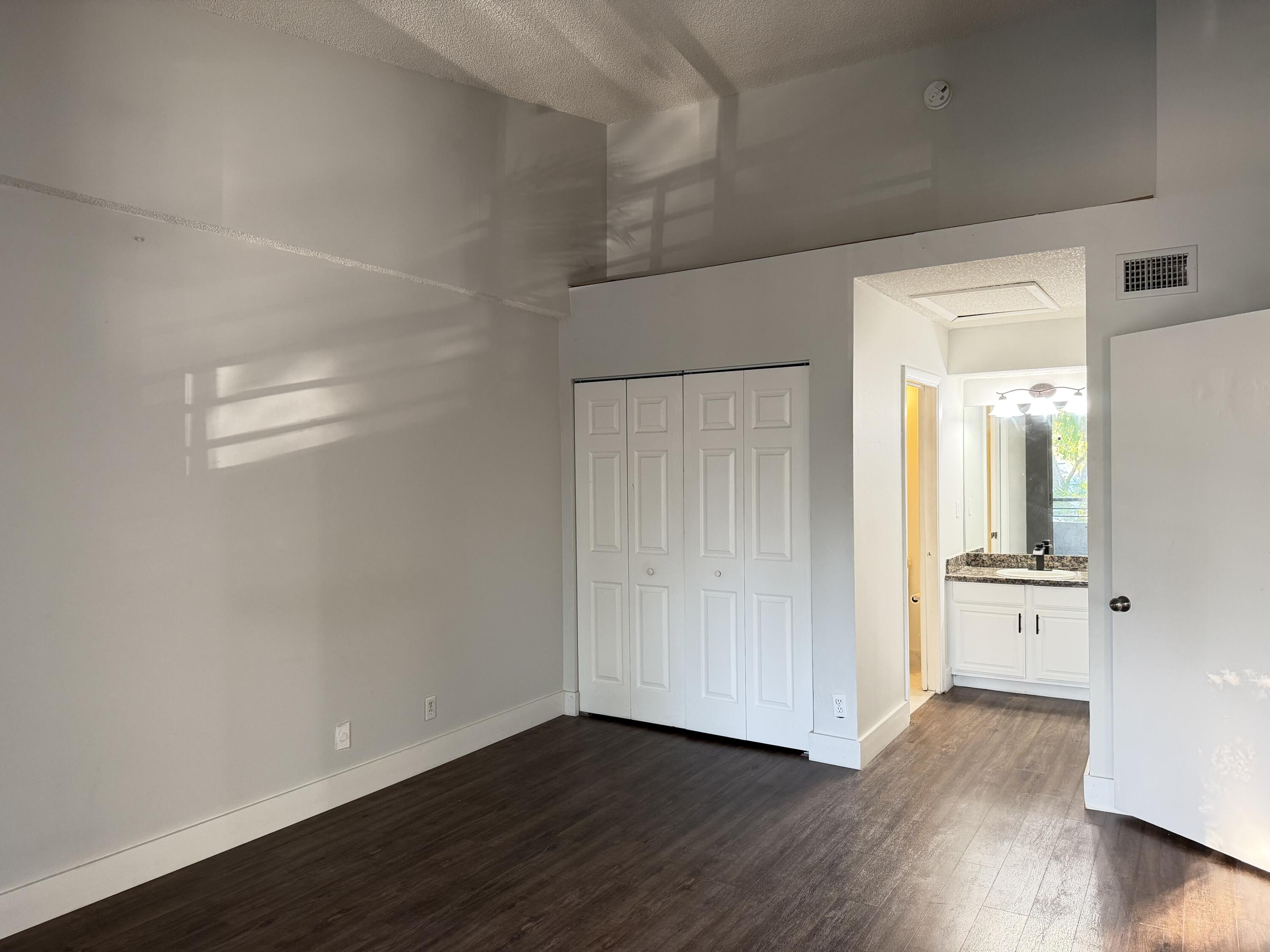 921 Lyons Road, Unit 3205 Coconut Creek, FL 33063 - Photo 5 of 17 wooden floor in an empty room