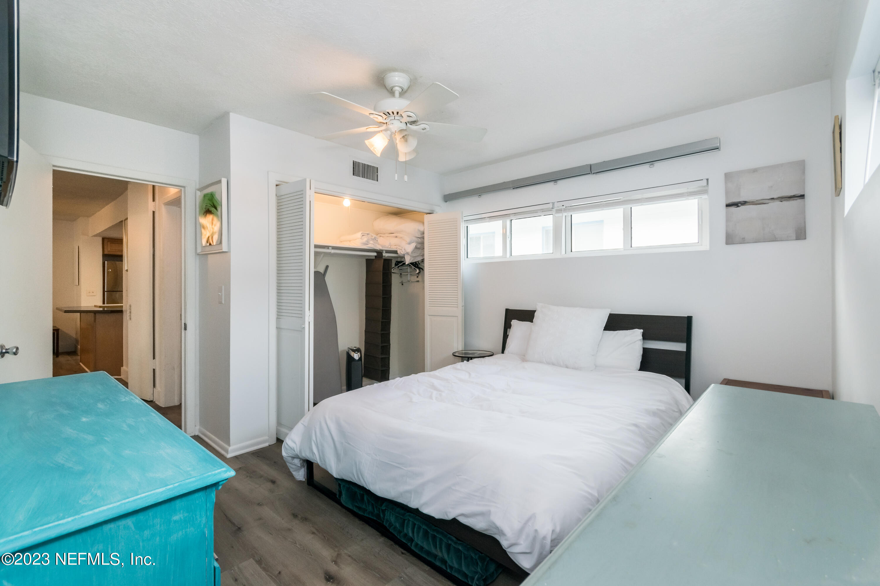 1632 Strand Street Neptune Beach, FL 32266 - Photo 11 of 22 a bedroom with a large bed and a chandelier