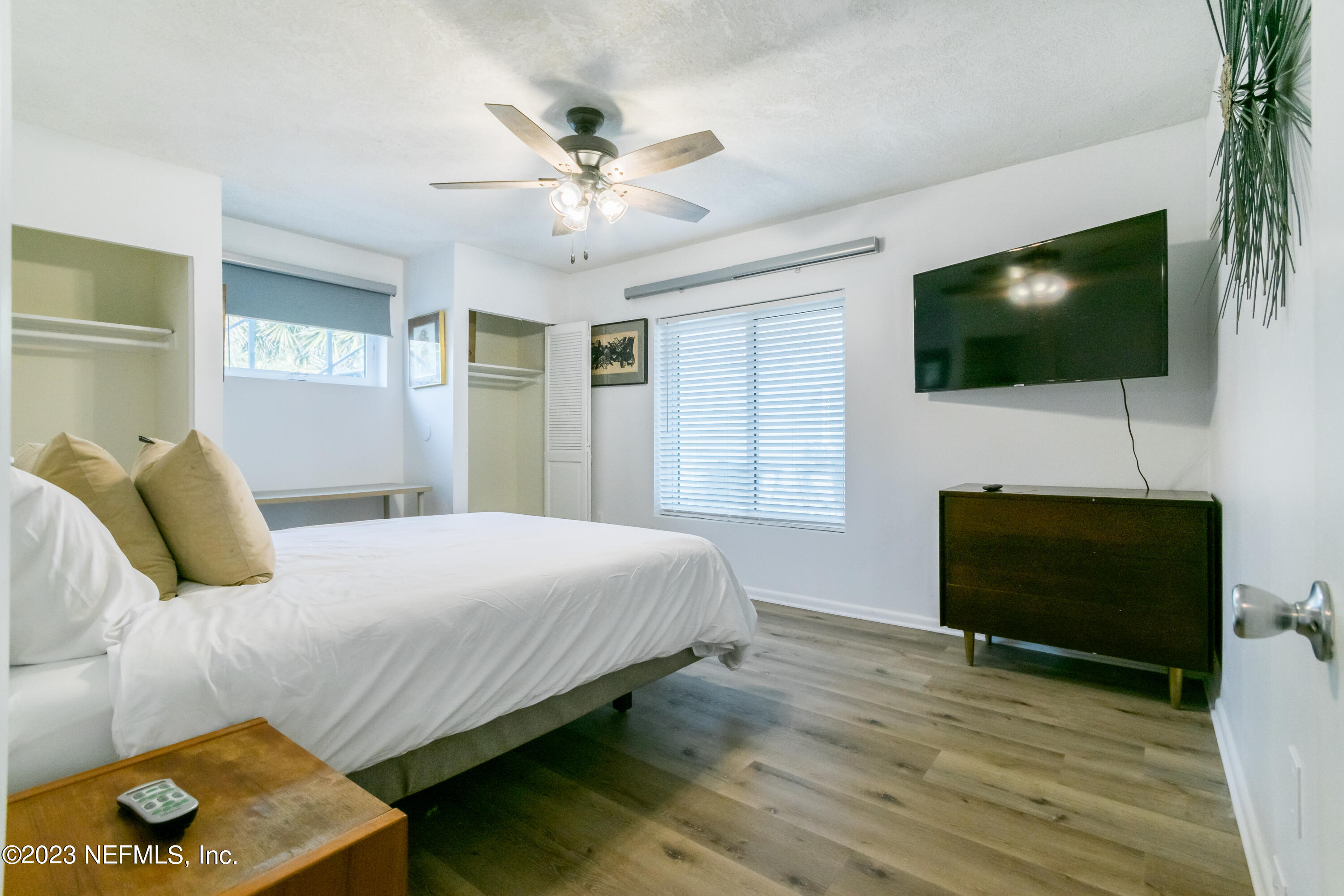 1632 Strand Street Neptune Beach, FL 32266 - Photo 13 of 22 a bedroom with a bed and a flat screen tv