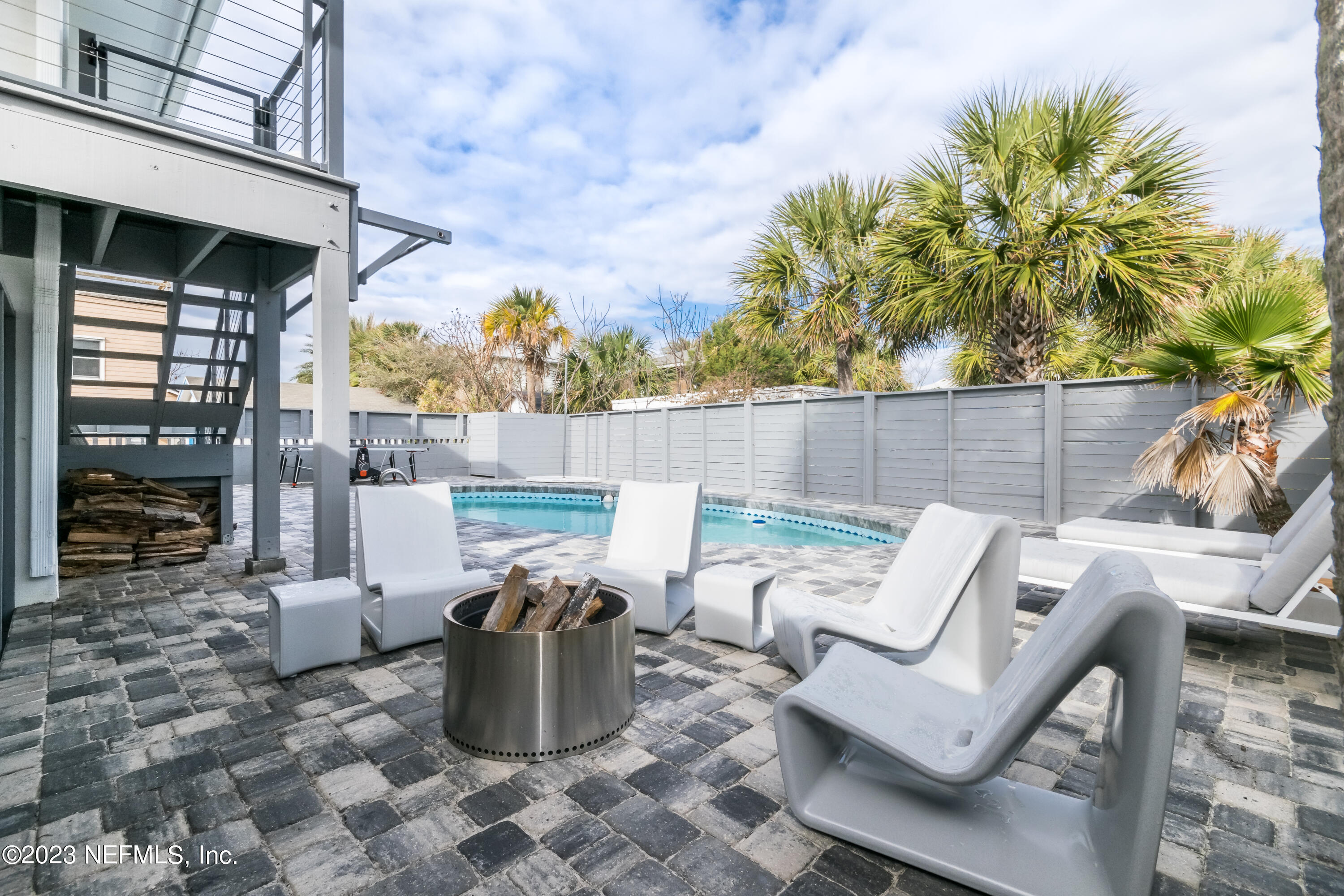 1632 Strand Street Neptune Beach, FL 32266 - Photo 18 of 22 a view of a patio with couches chairs and potted plants