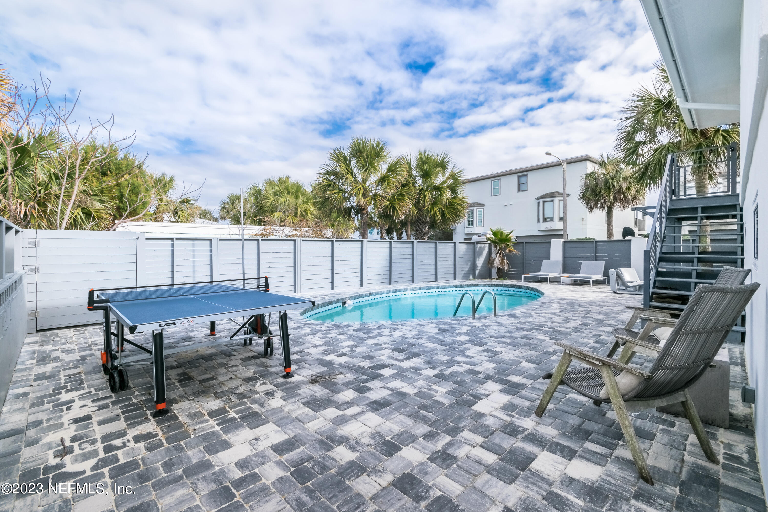1632 Strand Street Neptune Beach, FL 32266 - Photo 19 of 22 a backyard of a house with table and chairs