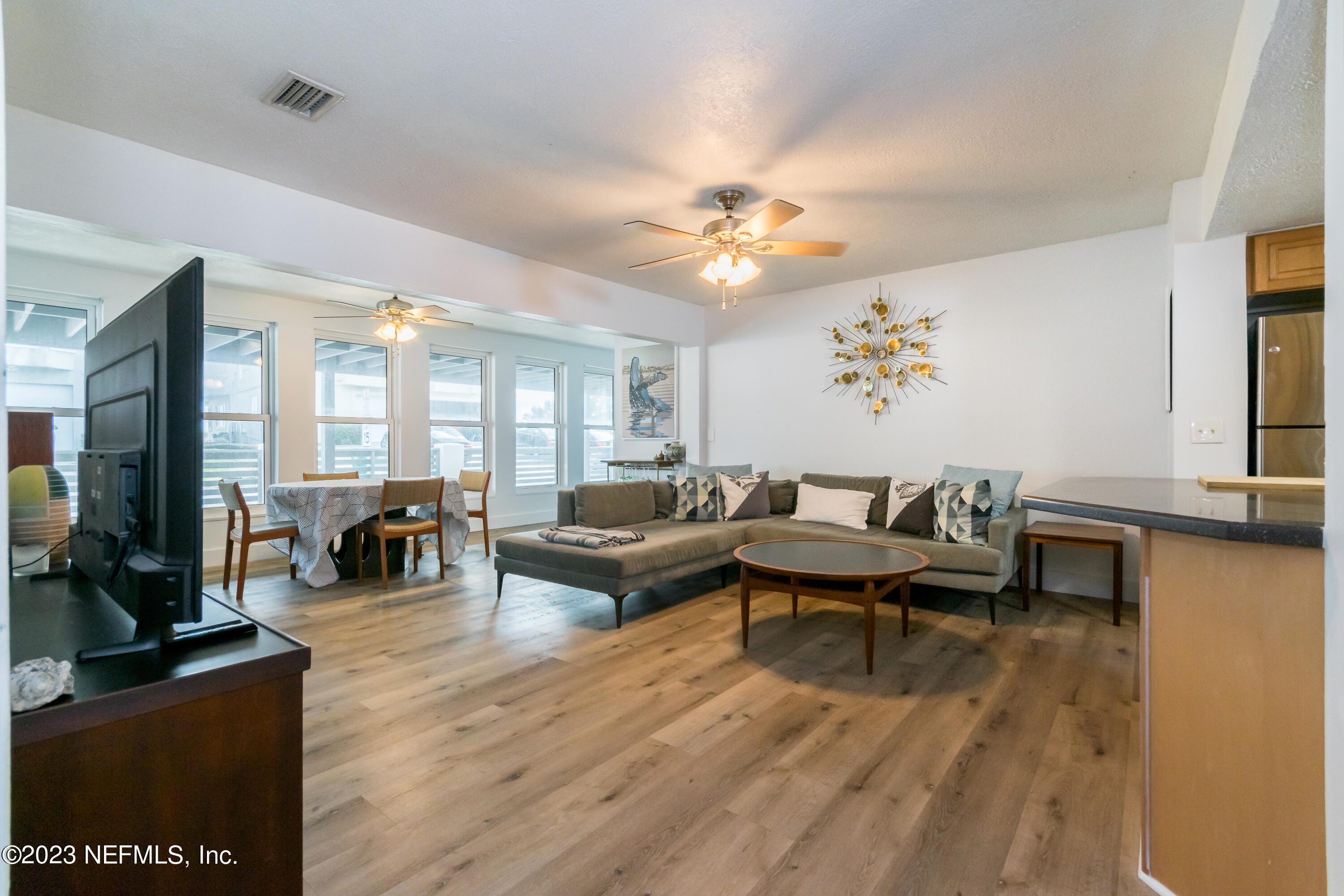 1632 Strand Street Neptune Beach, FL 32266 - Photo 4 of 22 a living room with furniture a dining table and a fireplace