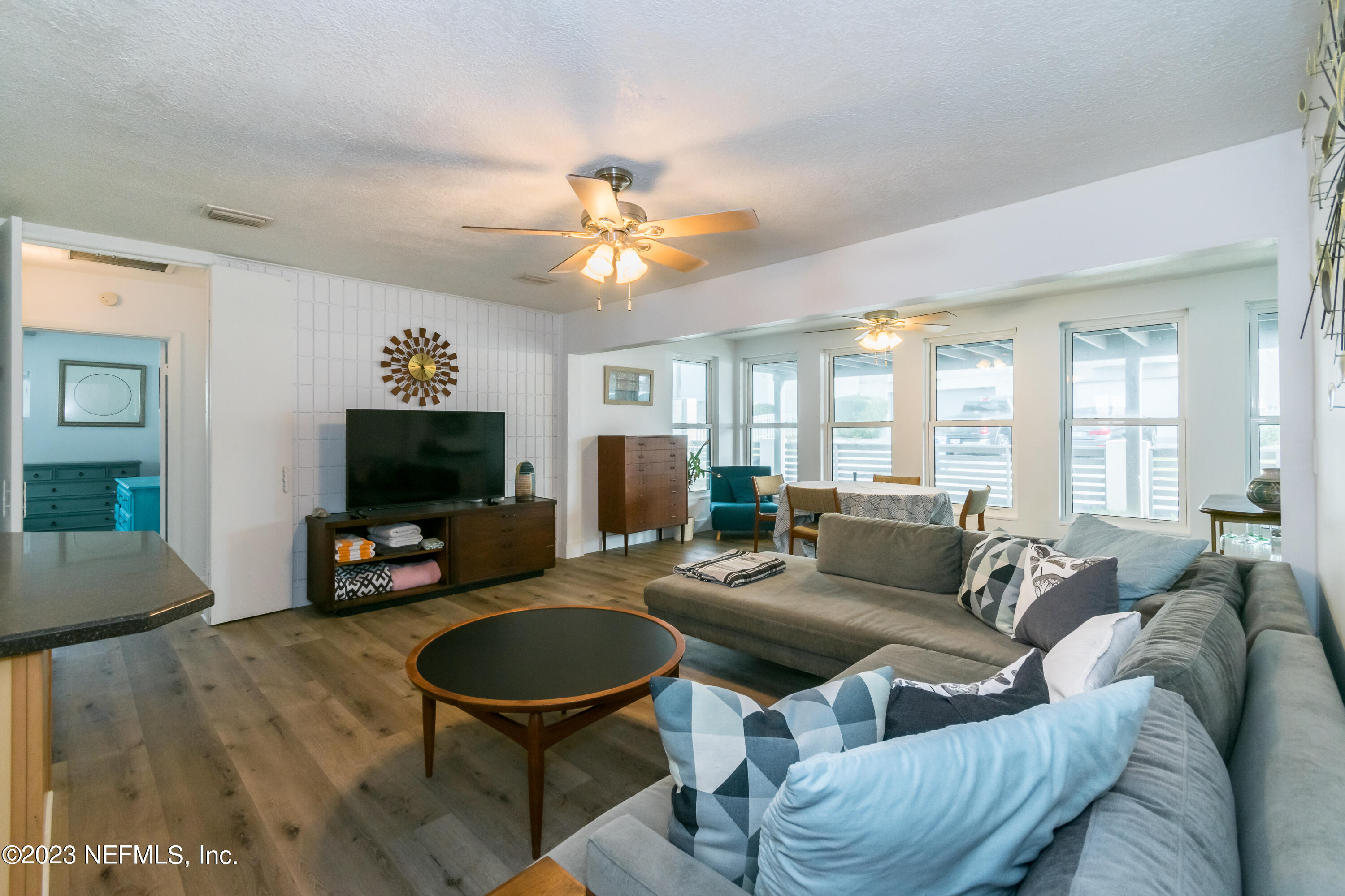 1632 Strand Street Neptune Beach, FL 32266 - Photo 5 of 22 a living room with furniture a fireplace and a flat screen tv