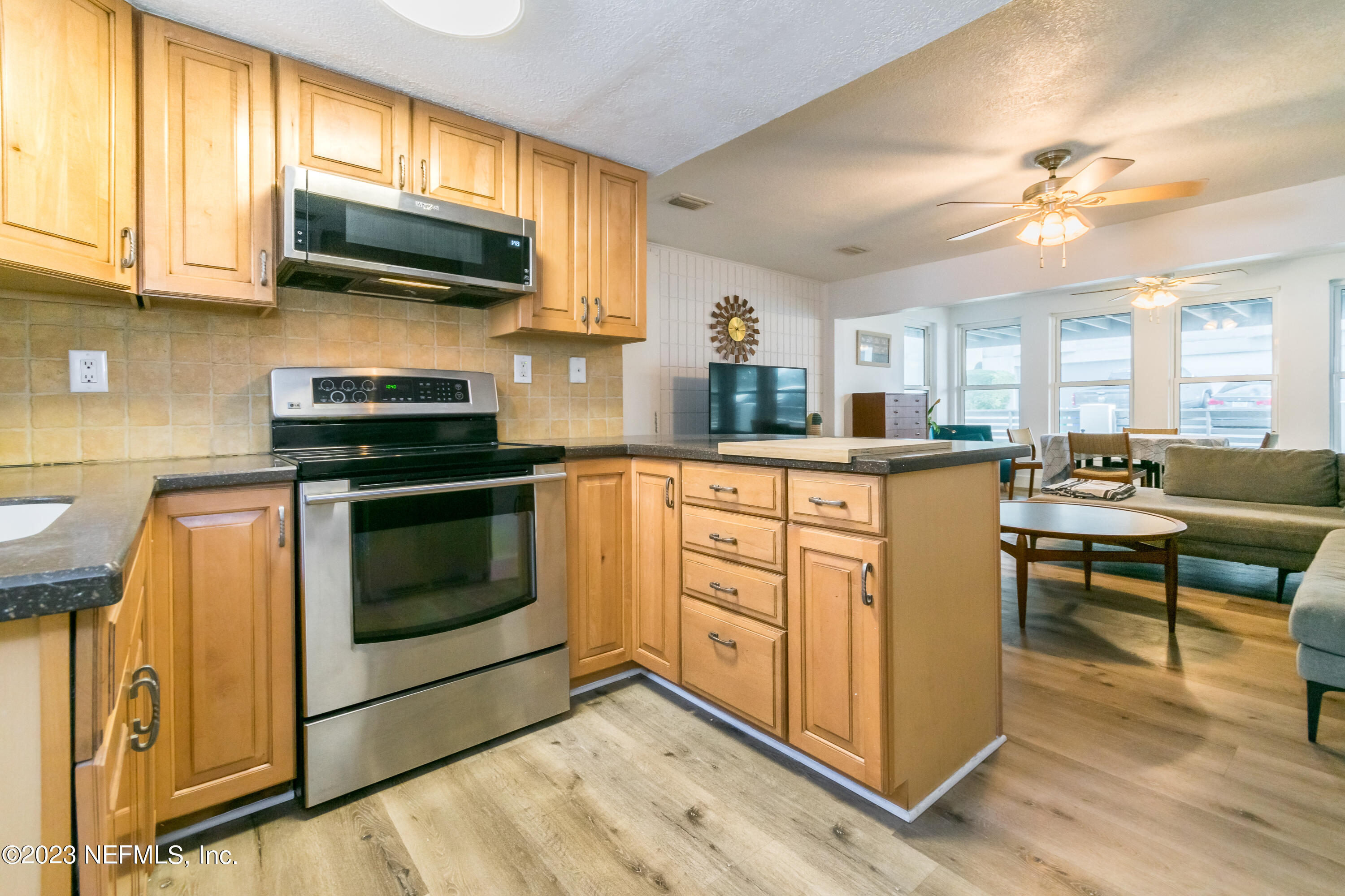 1632 Strand Street Neptune Beach, FL 32266 - Photo 8 of 22 a kitchen with stainless steel appliances stove microwave and cabinets