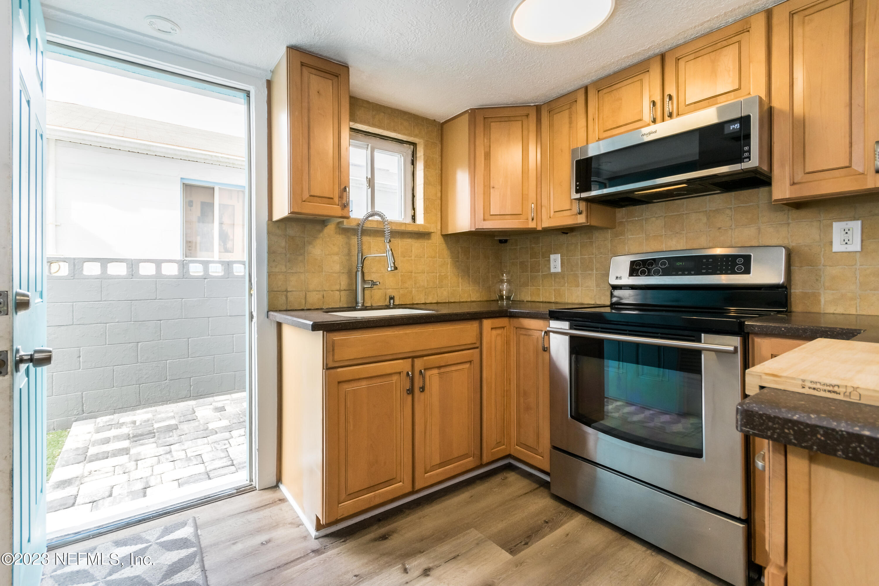 1632 Strand Street Neptune Beach, FL 32266 - Photo 9 of 22 a kitchen with stainless steel appliances granite countertop a stove microwave and sink