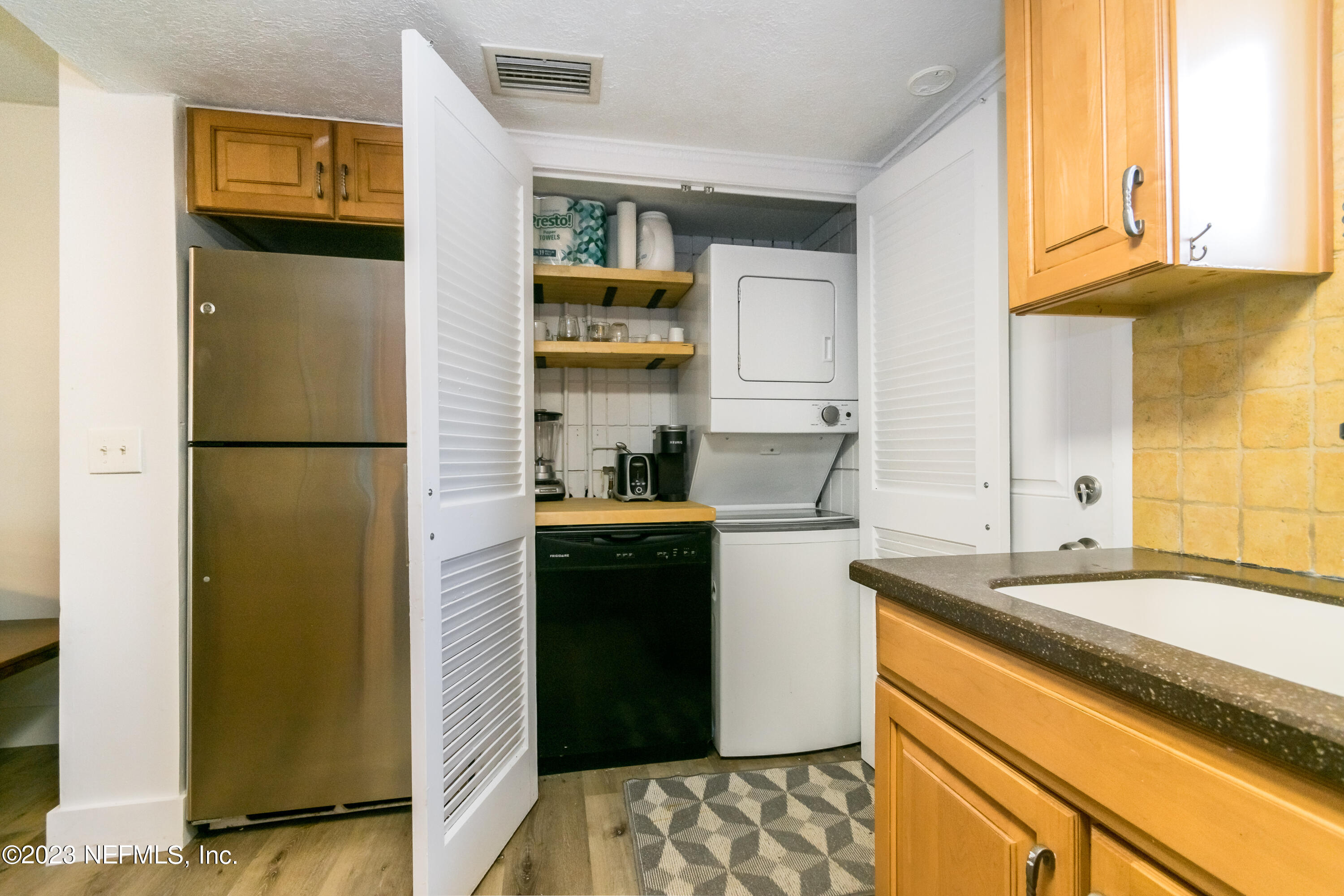 1632 Strand Street Neptune Beach, FL 32266 - Photo 10 of 22 a kitchen with stainless steel appliances granite countertop a refrigerator and a sink