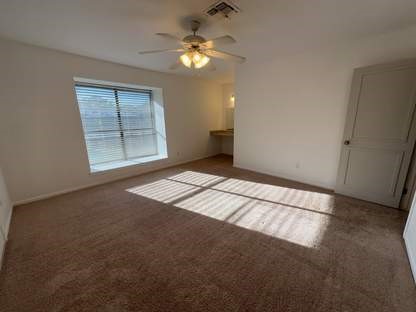1919 Place Rebecca Lane, Unit H11 Houston, TX 77090 - Photo 11 of 18 an empty room with windows and fan